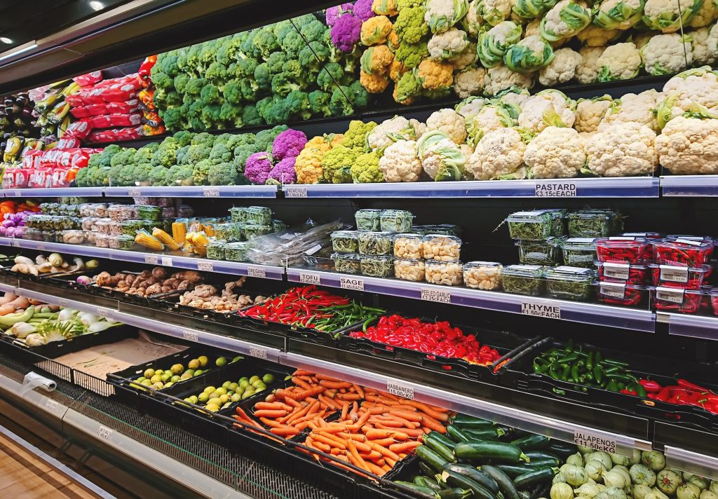 View of vegetable counter in supermarket. Fruits and vegetables on store stand in supermarket