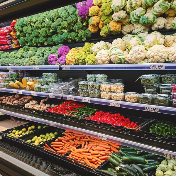 View of vegetable counter in supermarket. Fruits and vegetables on store stand in supermarket